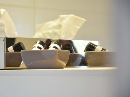 a bunch of bottles of wine sitting on a shelf at Hotel Restaurant "Zur Post" in Holdorf