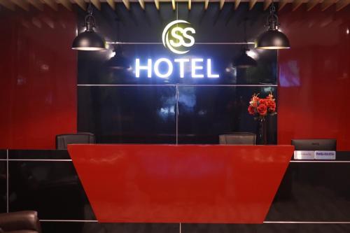 a hotel sign on a wall with a red desk at S.S.Hotel Nangrong in Nang Rong