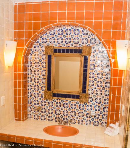 a bathroom with a sink and a mirror at Hotel Real de Naturales in Cholula