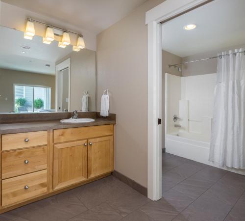 a bathroom with a sink and a mirror and a tub at WorldMark Windsor in Windsor