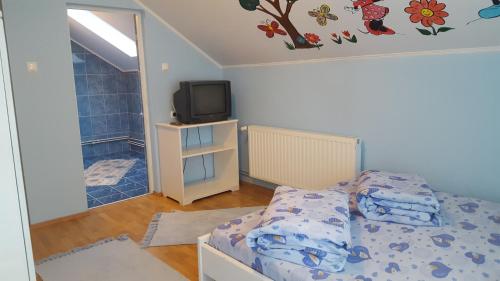 Postel nebo postele na pokoji v ubytování Szandi Panzió