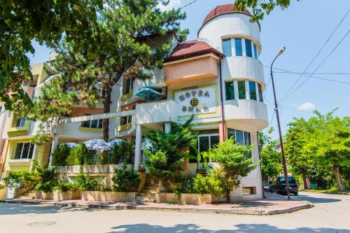 an apartment building with a turret at Vida Family Hotel in Vidin