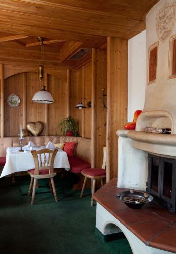 a dining room with a table and a fireplace at Hotel Donauhof in Emmersdorf an der Donau
