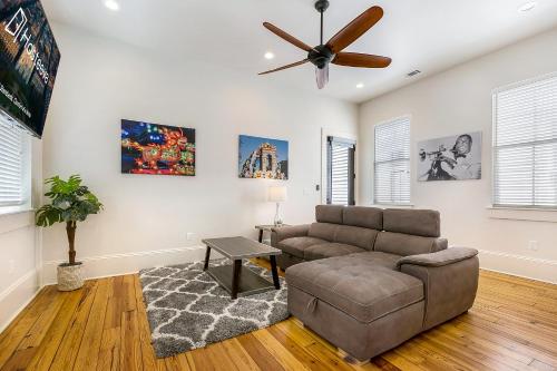 a living room with a couch and a ceiling fan at Fabulous Cottages with City Views in New Orleans