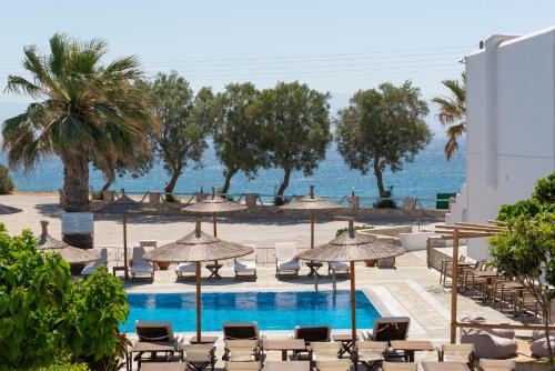 a view of a pool with chairs and umbrellas at Christiana Hotel in Ambelas