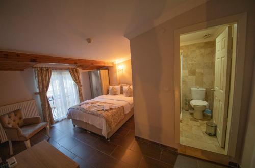 Postel nebo postele na pokoji v ubytování Ağva Carpediem Otel