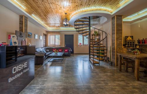 a living room with a spiral staircase in a room at OISHE Boutique Hotel in Stepantsminda