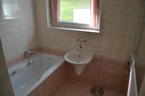 a bathroom with a sink and a bath tub and a toilet at Granny's in Tvrdošín