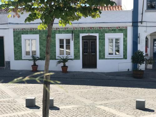 a building with a tree in front of it at Casa DAlva in Vila Alva