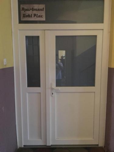a door with a sign on top of it at Apartment Nobl plac in Celje