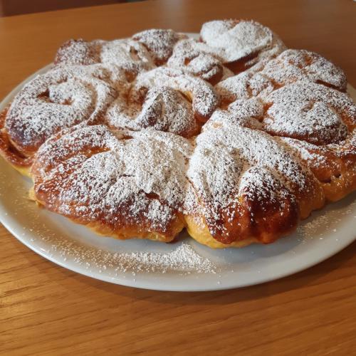 a plate of sugar powdered donuts on a table at Boutique Hotel Palazzo Corso Umberto in Boiano