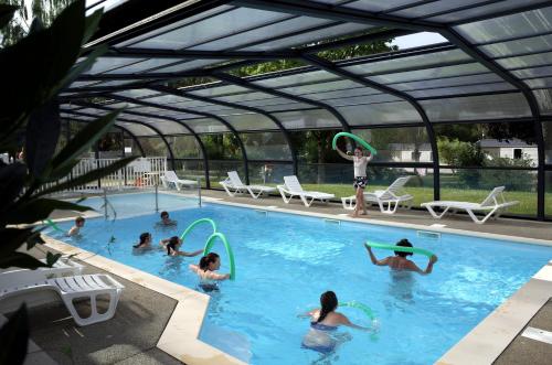 a group of people playing frisbee in a swimming pool at Camping de Saverne in Saverne