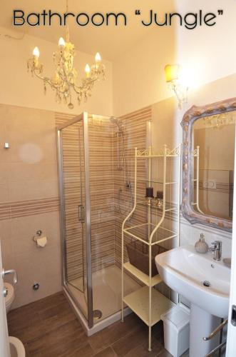 a bathroom with a shower and a sink and a mirror at Room & Breakfast Nettuno 29 in Bologna