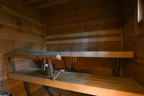 an inside of a sauna with a wooden wall at Joutsen Holiday Home in Luosto