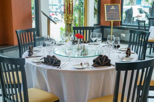 a table with a white table cloth and wine glasses at Kampong Thom Royal Hotel in Kompong Thom