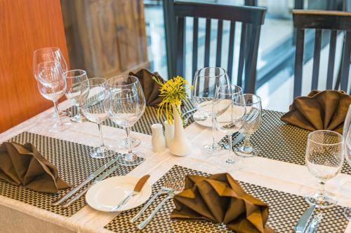a table with wine glasses and napkins on it at Kampong Thom Royal Hotel in Kompong Thom