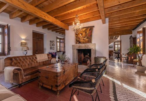 a living room with a couch and a fireplace at Restored Winery On The Atlantic 3bedroom house in Sintra