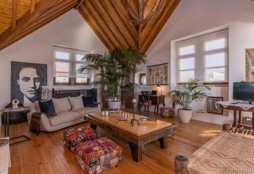 a living room with a couch and a table at Restored Winery On The Atlantic 3bedroom house in Sintra