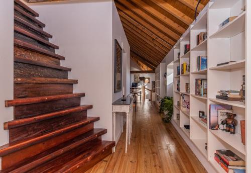 a hallway with wooden stairs in a house at Restored Winery On The Atlantic 3bedroom house in Sintra