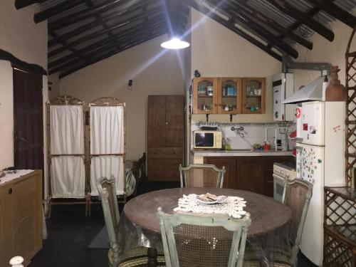 a kitchen with a table with chairs and a refrigerator at Las Azaleas Yala in Yala