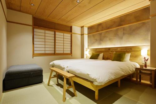 Кровать или кровати в номере nid Osaka Kurosaki