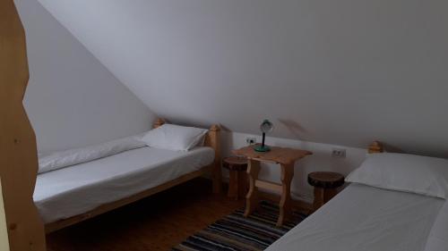 a small room with two beds and a table at Bucovina mea in Breaza