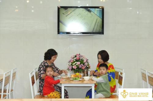 a group of women and children sitting at a table at Golden Bee Hotel in Da Lat