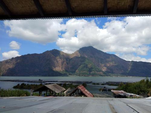 a view of a body of water with a mountain at Volcano Living in Kintamani