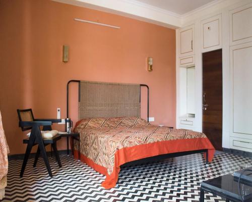 a bedroom with a bed and a table and a desk at Jaisal Castle Homestay in Jaipur