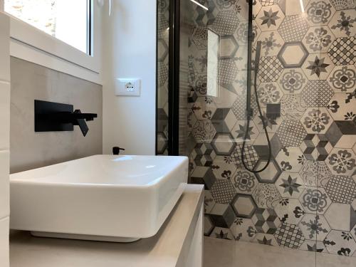 a bathroom with a white sink and a shower at Al Castello in Dolceacqua