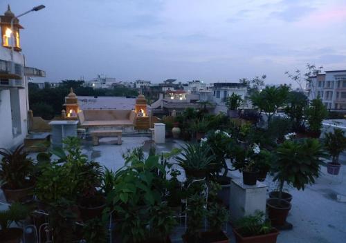 a view of a courtyard with potted plants on a building at Jaisal Castle Homestay in Jaipur
