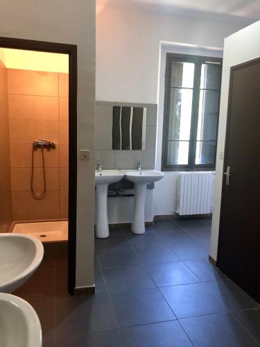une salle de bain avec deux lavabos et une douche dans l'établissement U Castellu, à Vero