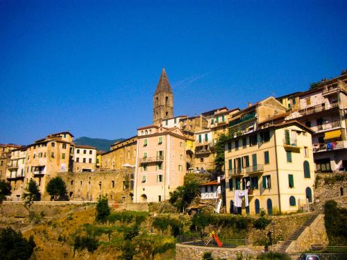 a group of buildings on a hill with a church at Old Mill in Pigna