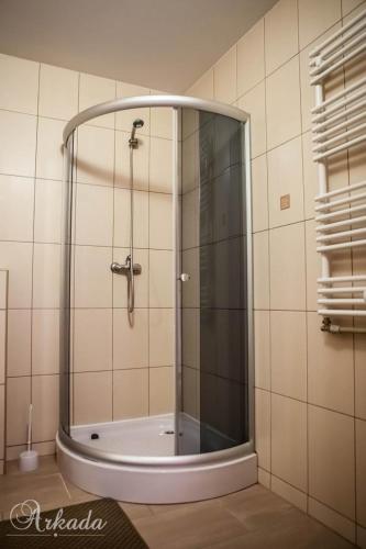 a shower with a glass door in a bathroom at Hotel Arkada in Rawa Mazowiecka