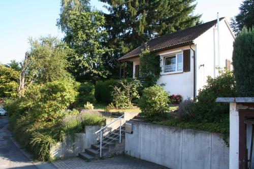 a white house with a staircase in a yard at Bergblick in Siedelsbrunn