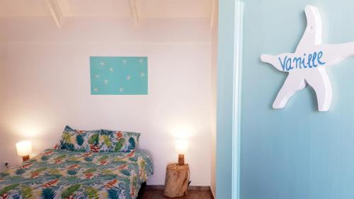 a bedroom with a bed and a stuffed animal on the wall at Hotel & Apartments "CHEZ HIVA" in Hanga Roa