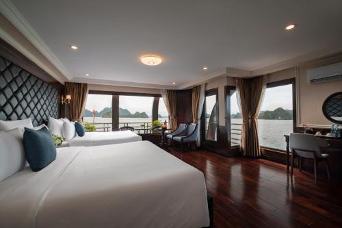 a bedroom with a large bed with a view of the water at La Pandora Cruises in Ha Long