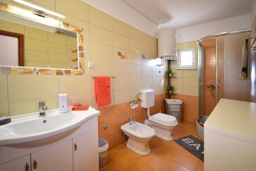 a bathroom with a sink and a toilet and a shower at VILLA DINJA in Gizdavac