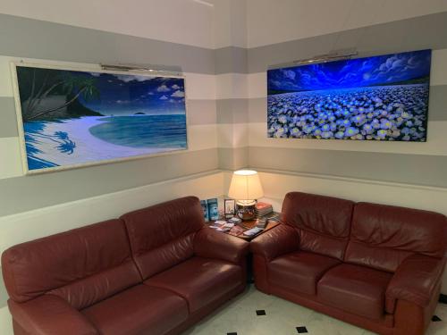 a living room with a couch and a table with a lamp at Hotel Cavour in Rapallo