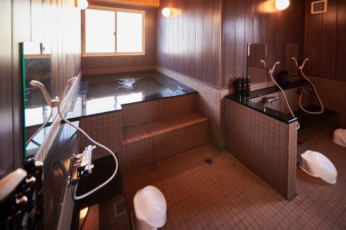 a large bathroom with a tub and a sink at Hotel Select Inn Isehara in Isehara