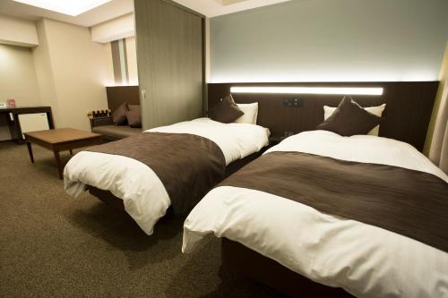 Ένα ή περισσότερα κρεβάτια σε δωμάτιο στο Lantana Osaka