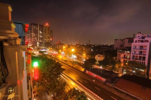 a city at night with traffic lights and buildings at Golden Hotel in Hanoi