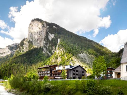 a resort with a mountain in the background at Hotel Krone in Au in Au im Bregenzerwald