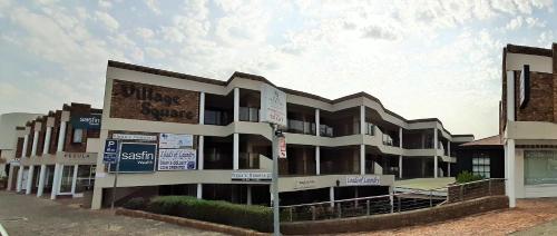a building with signs on the side of it at Village Square 10 in Plettenberg Bay