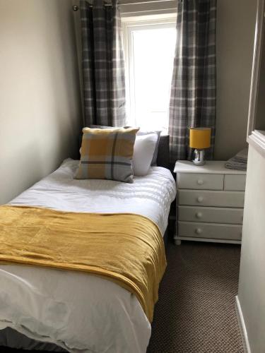 a small bedroom with a bed and a window at 34 Brunton Street Serviced Accommodation in Darlington