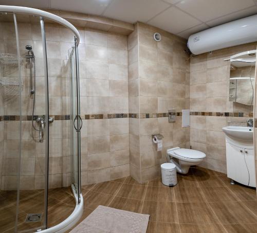 a bathroom with a shower and a toilet at RIVERSIDE APARTMENTS PLOVDIV with free parking in Plovdiv