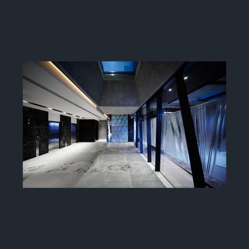 a hallway of a building with a glass wall at Flinders Street Apartments in Melbourne