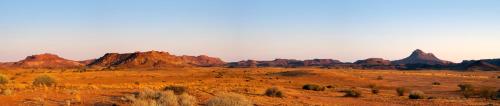 a view of the desert with mountains in the background at Twyfelfontein Country Lodge in Twyfelfontein