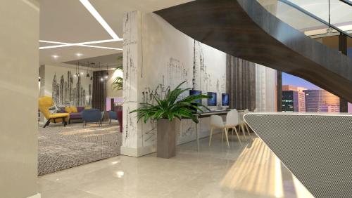a lobby with a potted plant in a building at Mercure Dubai Barsha Heights Hotel Suites And Apartments in Dubai