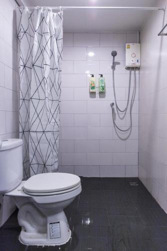 a bathroom with a toilet and a shower at T1 Large Studio Full kitchen 100m. to BTS in Bangkok